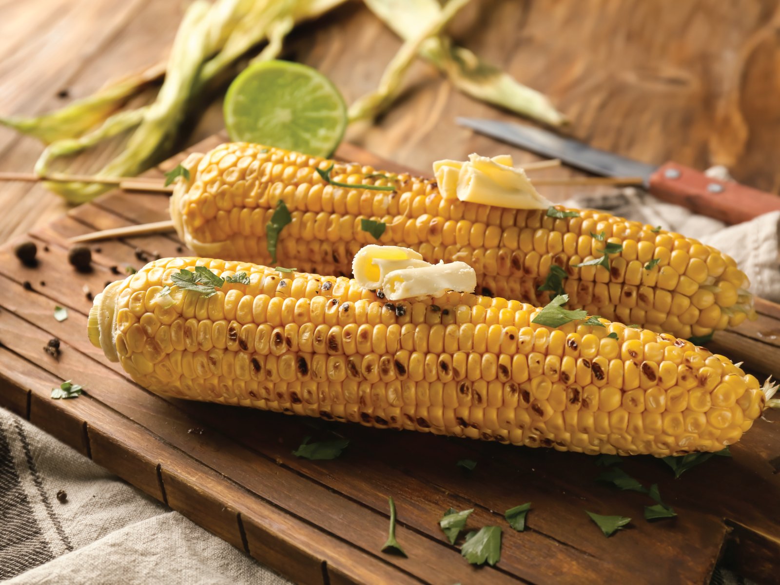 Grilled corn with herb butter — delicious side with any dish.